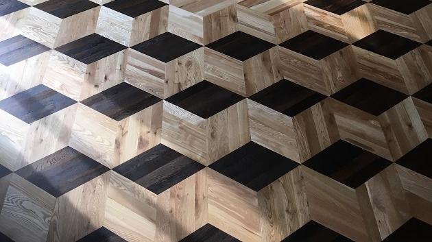 The Hall of Mirrors at Dahlen Castle featuring a parquet-patterned floor installed by members of Workcamp Parquet